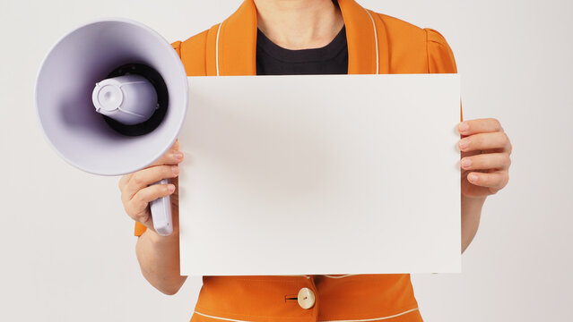Woman is wearing a yellow mustard suit and holding the blank paper board on white background. Body part.