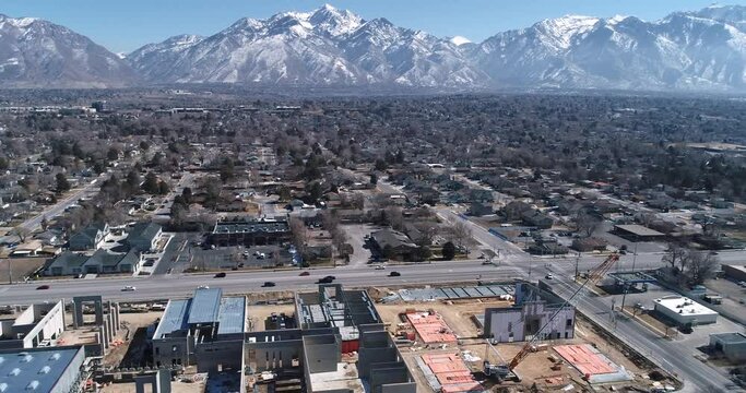 School construction in Sandy Utah with Wasatch Mountains in the background drone footage