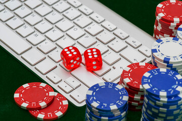 Gambling online casino Internet betting concept. Jackpot, casino chips. computer keyboard, laptop with poker chips, dice. Casino tokens, gaming chips, checks, or cheques