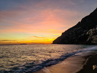 Panoramic sunset view on Marina Grande Beach and colorful buildings of hillside village Positano at...