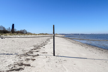 An area cordoned off with ropes and stakes on the beach of the Baltic Sea.