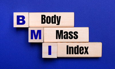 On a bright blue background, light wooden blocks and cubes with the text Body Mass Index BMI