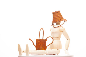 image of wooden figure rusty miniature bucket watering can white background