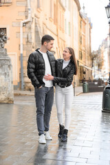 Lovely young couple walking together on city street. Romantic date