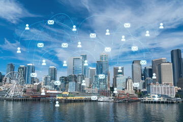 Fototapeta premium Seattle skyline with waterfront view. Skyscrapers of financial downtown at day time, Washington, USA. Social media hologram. Concept of networking and establishing new people connections