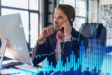 Businessman in suit has conference call to optimize trading strategy at corporate finance fund. Forex chart hologram over office background with panoramic windows