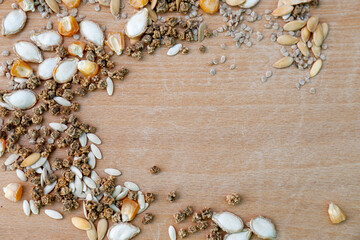 Fototapeta premium Different vegetable seeds on wooden table, flat lay. Space for text