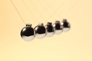 Newton's cradle on color background, closeup. Physics law of energy conservation