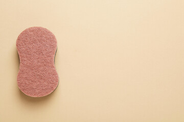 New sponge on beige background, top view. Space for text