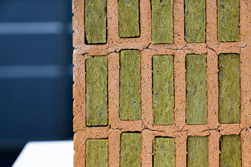 Construction brick with mineral wool insulation