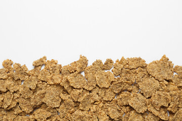 Sweet tasty corn flakes on white background, top view