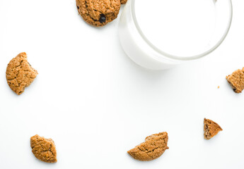 Chocolate chip cookies with glass of milk on wood plate and isolated white background. 