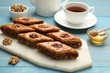 Delicious sweet baklava with walnuts on turquoise wooden table
