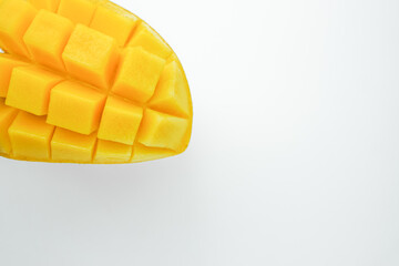 Fresh mango cut half and cube slice. Tropical fruit with isolated white background. Popular sweet dessert in Thailand.