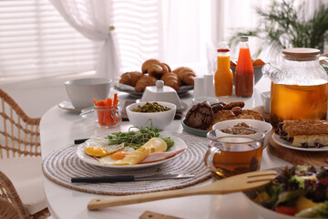 Many different dishes served on buffet table for brunch