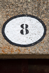 Number Eight on Stone Wall