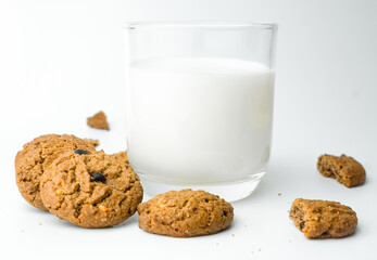 Chocolate chip cookies with glass of milk on wood plate and isolated white background. 