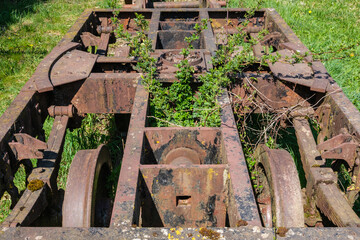 Alter mit Gras durchwachsener Eisenbahn-Wagen, der immer mehr verwildert.