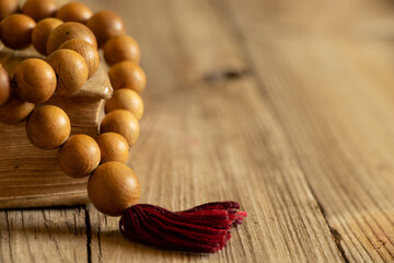 Wooden rosary lie on the bible on a wooden table, bible and religion, faith