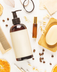Mock up of Hair care cosmetics. Hair care card with shampoo bottle, combs, organic soap, oil, lemon and coffee beans on white background. Mock up of natural beauty products for hair. Soft image style