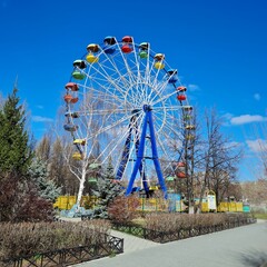 Ferris wheel in the park with colorful cabanas