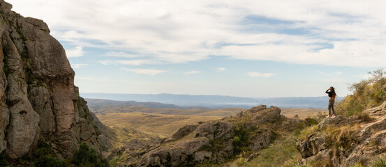 Horizontal view of unrecognizable backpacker sightseeing in Zumaia cliffs. Horizontal panoramic view of man traveling in vasque country. People and travel destination in Spain