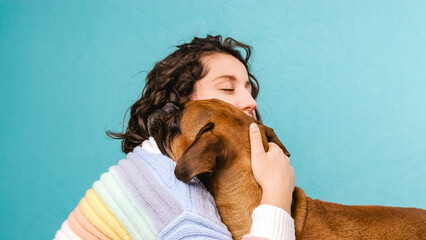 Woman hugging her cute boxer dog. Animals and pets concept.