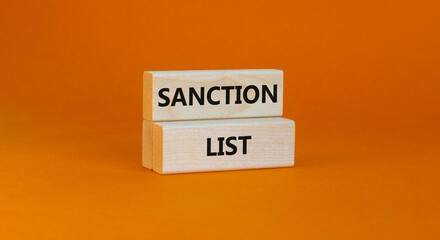 Sanction list symbol. Wooden blocks with concept words Sanction list on beautiful orange background. Business political sanction list concept. Copy space.