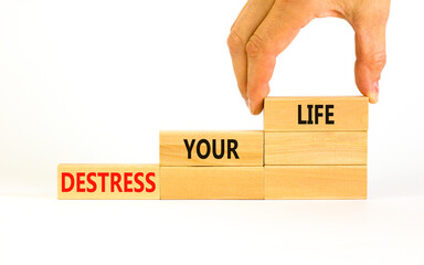 Destress your life symbol. Concept words Destress your life on wooden blocks. Doctor hand. Beautiful white table white background. Psychological business and destress your life concept. Copy space.