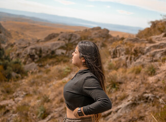 Portrait of latin woman having fun during trekking day in mountain forest - Focus on face