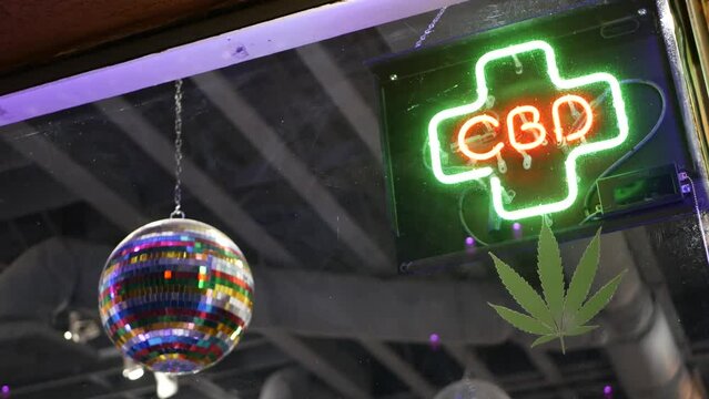 Neon sign in smoke shop, legalized cbd oil or medical cannabis in store, California USA. Legal sale of cannabidiol, weed, hemp, marijuana, ganja or hashish in dispensary. Cannabinoids in drugstore.