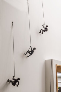 Hanging figures decorating white wall in room