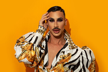 Portrait of drag queen with fashionable mustache yellow background - obrazy, fototapety, plakaty