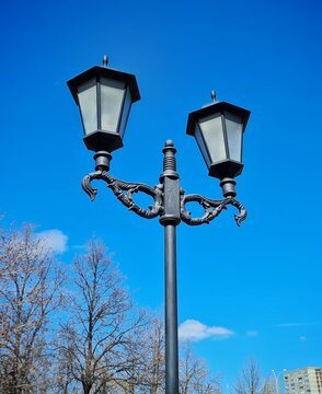 Retro lanterns on a black cast iron pole
