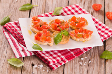 Friselle with cherry tomatoes and basil.