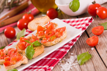 Friselle with cherry tomatoes and basil.
