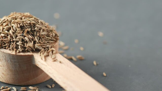 cumin seeds on spoon on table , close up 