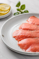smoked red fish slices on a plate