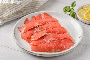 smoked red fish slices on a plate