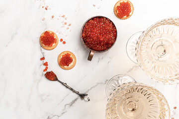Delicious snacks with cream cheese and red caviar with glass of champagne, Festive drink. Valentins...