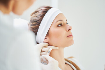 A scene of medical cosmetology treatments botox injection. - 503323777