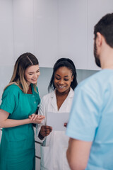 Fototapeta premium Multiracial team of doctors discussing a patients condition while working in a hospital