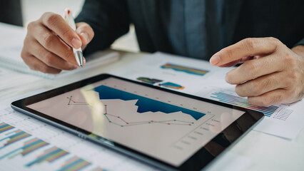 businessman working on project for analyzing company financial statistic result with smart device at modern office space. Concept for business, economy and tax