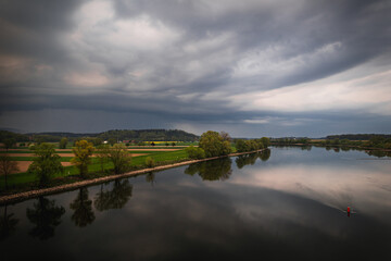 Dark storm clouds in the evening sky at the Danube in Bavaria, Germany