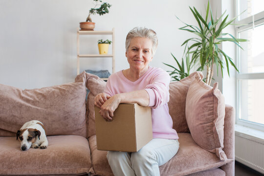 Smiling Older Adult Mature Woman Customer Unpacking Parcel