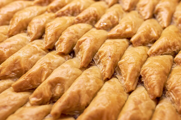 Rows with appetizing sweet Turkish baklava as a background or backdrop
