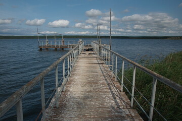 an old metal pier with railings on the Volga river. Ulyanovsk