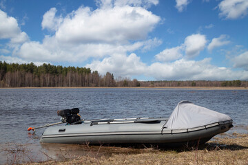 A rubber boat with an outboard motor on the lake.