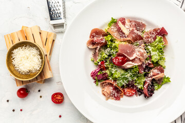 Salad with Prosciutto, ham and grapefruit jamon, salad mix, grapefruit, cherry tomatoes, parmesan cheese. Healthy food, keto diet, diet lunch concept