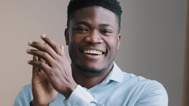 Amazed young african man happy american winner employee waving clapping hands approve looking at camera show thumb up agreement sign everything fine satisfied work result good choice close-up portrait